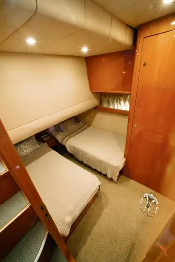  Yacht Photos Pics Interior cabin of 2004 Uniesse 57 yacht with twin beds and wooden finish.