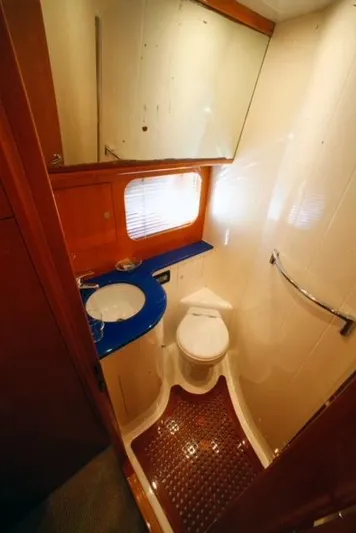  Yacht Photos Pics 2004 Uniesse 57 yacht bathroom with modern fixtures and blue countertop.