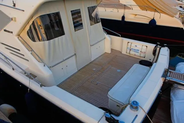  Yacht Photos Pics 2004 Uniesse 57 yacht with spacious deck and seating area.