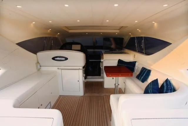  Yacht Photos Pics Luxurious interior of a 2004 Uniesse 57 yacht with elegant seating and wooden flooring.