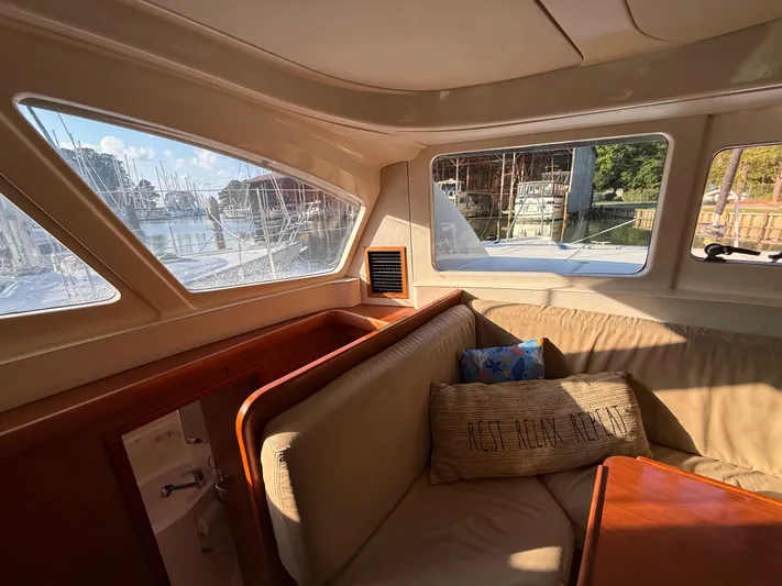 Selah Yacht Photos Pics Interior of 2010 Leopard 38 yacht with cozy seating and marina view.