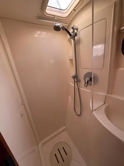 Selah Yacht Photos Pics Shower area in a 2010 Leopard 38 yacht, featuring a handheld showerhead and compact design.