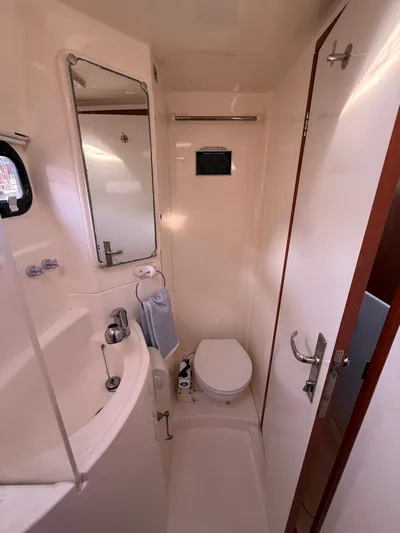 Selah Yacht Photos Pics Compact bathroom in a 2010 Leopard 38 yacht with sink, toilet, and mirror.