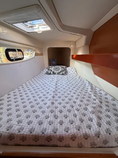 Selah Yacht Photos Pics Cozy cabin interior of 2010 Leopard 38 yacht with patterned bedding and wooden accents.