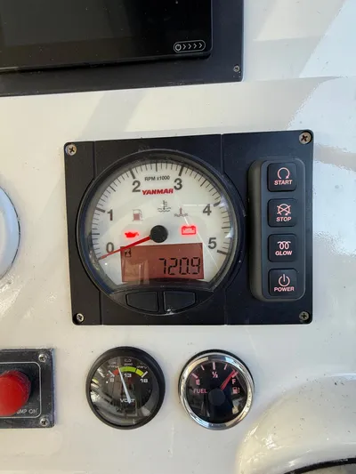 Selah Yacht Photos Pics Control panel of a 2010 Leopard 38 with Yanmar RPM gauge and buttons.