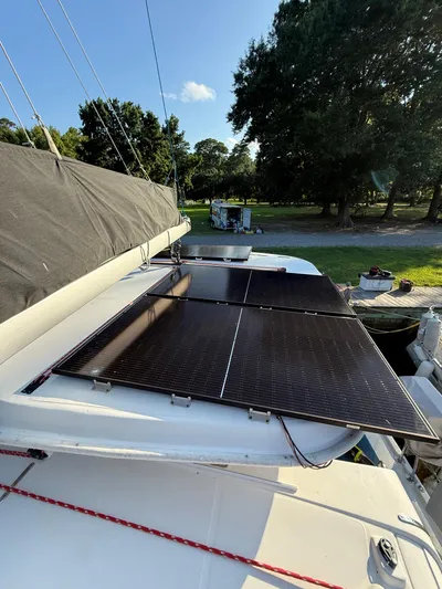 Selah Yacht Photos Pics Solar panels on a 2010 Leopard 38 catamaran under clear blue sky.