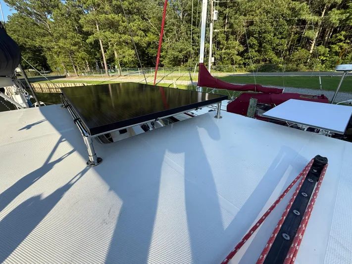 Selah Yacht Photos Pics Sailboat deck with solar panel, Leopard 38, 2010 model, surrounded by trees.