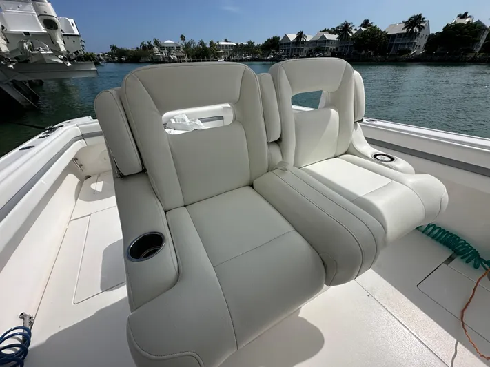  Yacht Photos Pics Luxurious seating on a 2015 Intrepid 400 Center Console boat, docked by the water.