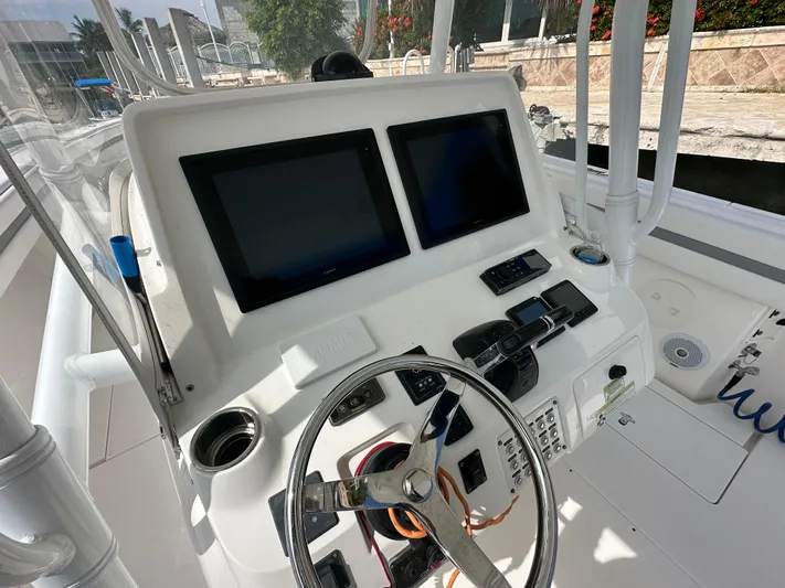 Yacht Photos Pics 2015 Intrepid 400 Center Console boat dashboard with dual screens and steering wheel.