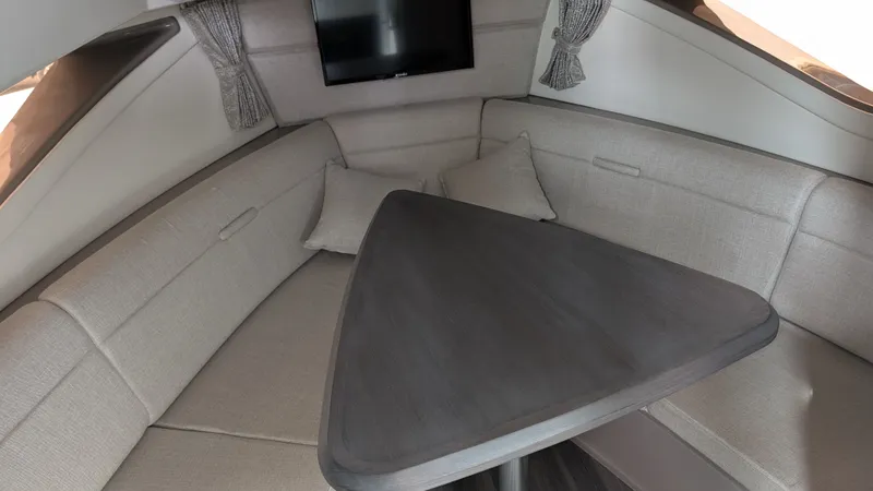  Yacht Photos Pics Interior of 2024 Sea Ray Sundancer 320 Coupe with gray table.