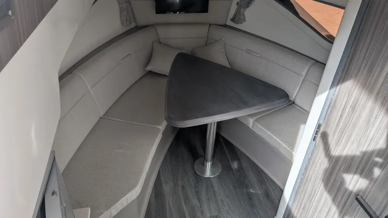  Yacht Photos Pics Interior of 2024 Sea Ray Sundancer 320 Coupe with gray table.