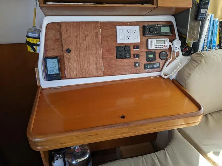 Guiding Light Yacht Photos Pics Navigation station on 1997 Lagoon 410 catamaran with control panel and communication devices.
