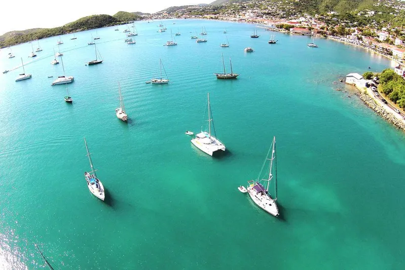Guiding Light Yacht Photos Pics Aerial view of Lagoon 410 sailboats in a serene bay, 1997 model.