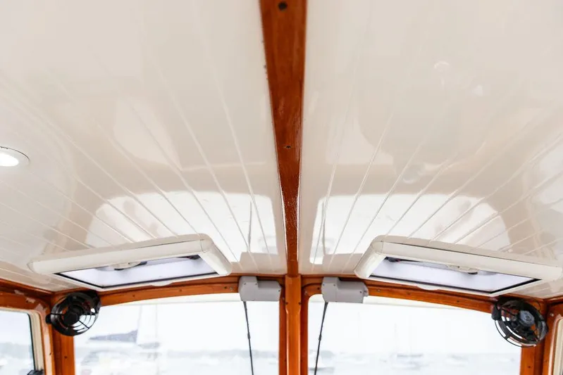 Calm Yacht Photos Pics Interior ceiling of a 1999 Hinckley Picnic Boat Classic with wood accents and lighting.