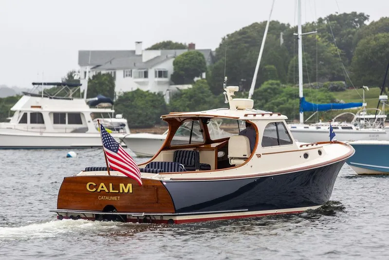 Calm Yacht Photos Pics 1999 Hinckley Picnic Boat Classic named "Calm" on water, displaying American flag.