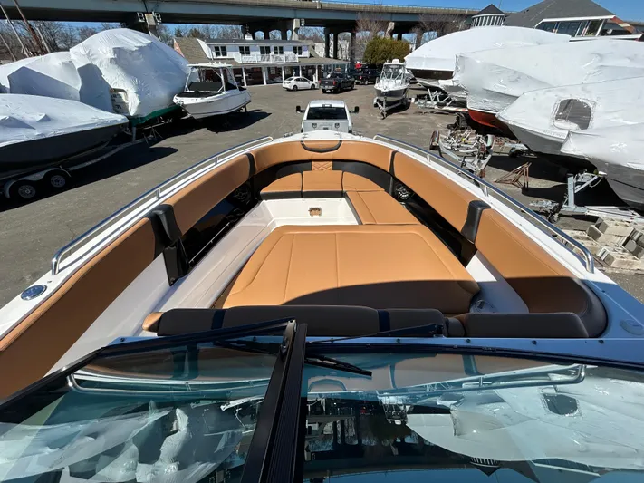  Yacht Photos Pics 2023 Chaparral 300 OSX boat with tan seating, docked among other boats.