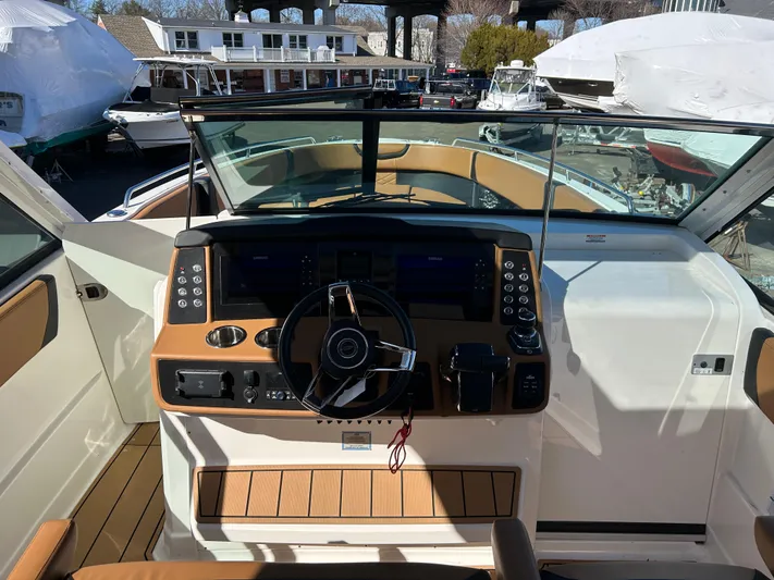  Yacht Photos Pics 2023 Chaparral 300 OSX boat cockpit with modern steering and control panel.