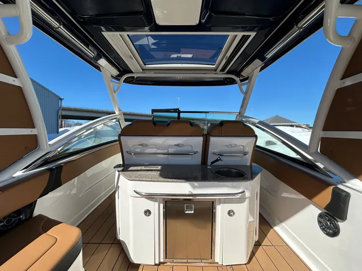  Yacht Photos Pics 2023 Chaparral 300 OSX boat interior with sleek design, kitchenette, and panoramic roof.
