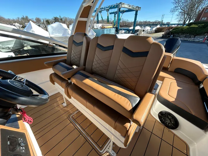  Yacht Photos Pics 2023 Chaparral 300 OSX boat interior with tan leather seating and modern design.