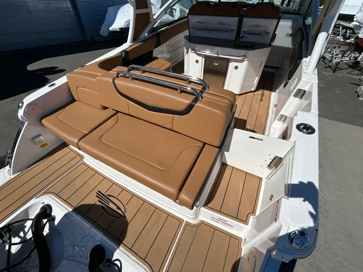  Yacht Photos Pics 2023 Chaparral 300 OSX boat interior with tan seating and wood flooring.