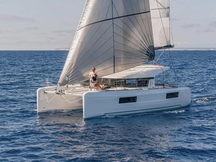 2020 Lagoon 40 catamaran sailing on open sea with full sails.