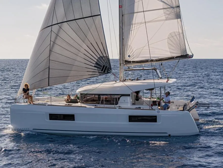 2020 Lagoon 40 catamaran sailing on open sea with full sails.
