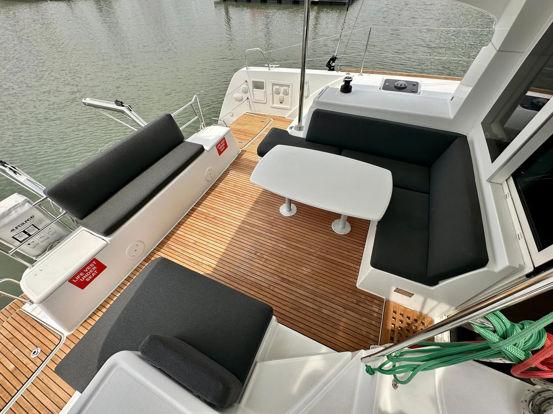 Spacious deck of 2020 Lagoon 40 catamaran with comfortable seating and table.