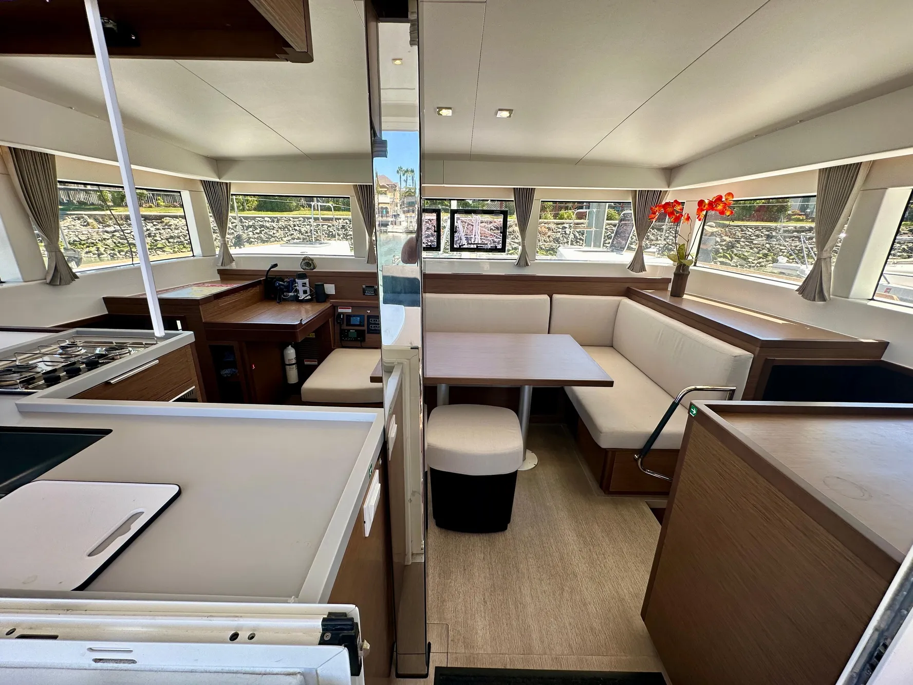 Interior of 2020 Lagoon 40 catamaran, featuring modern kitchen and dining area with ample seating.