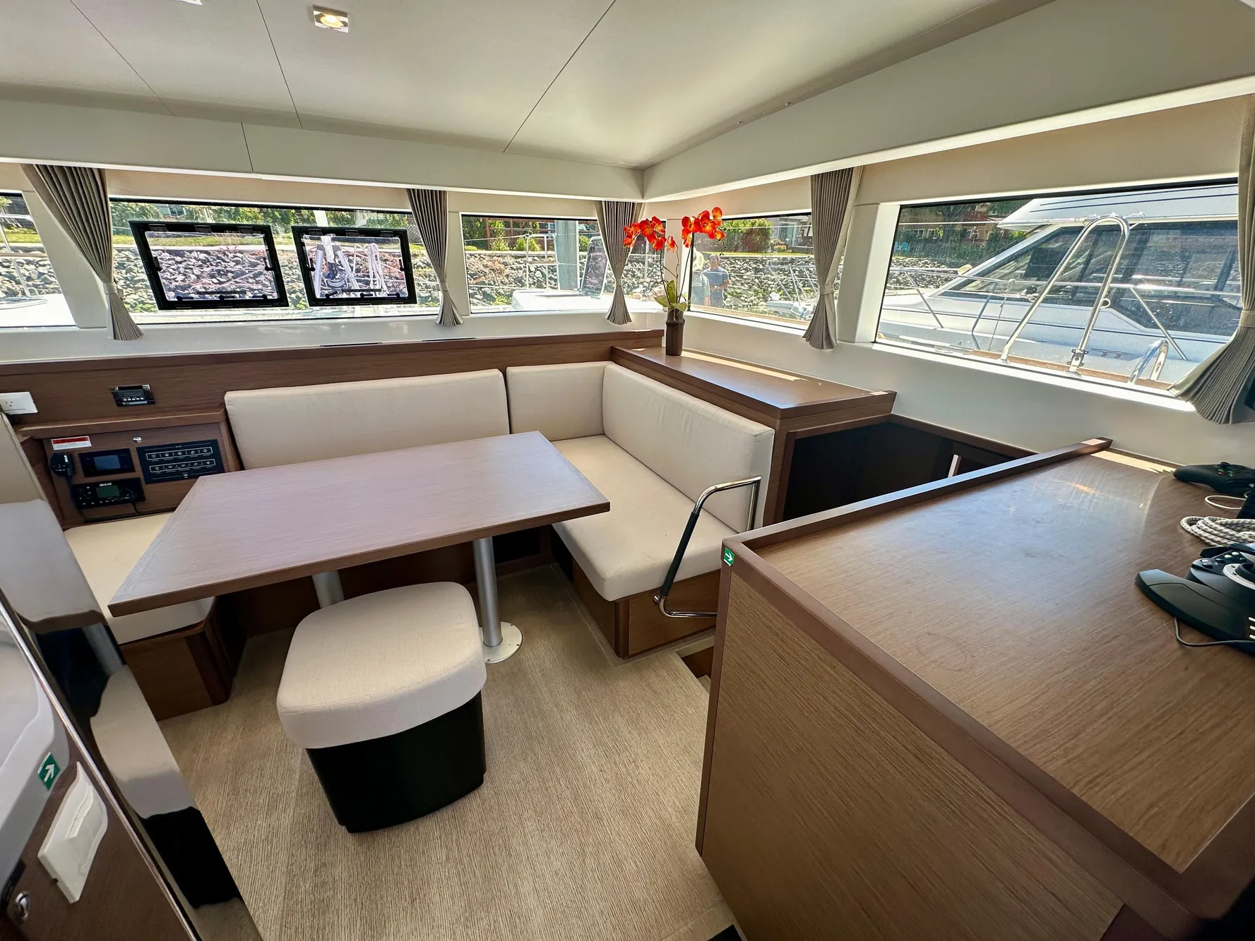 Modern interior of 2020 Lagoon 40 catamaran with spacious seating and large windows.