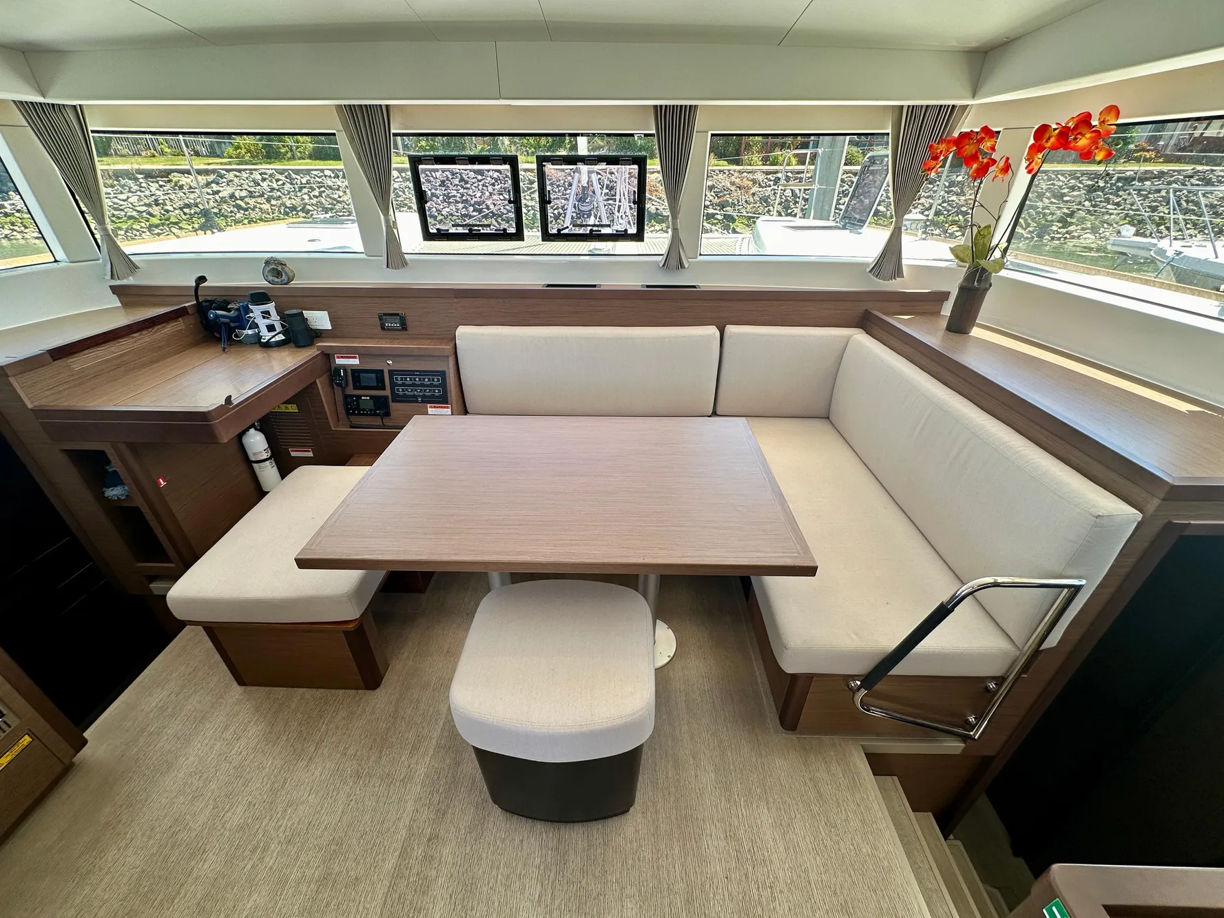 Interior of 2020 Lagoon 40 catamaran with modern seating and table arrangement.