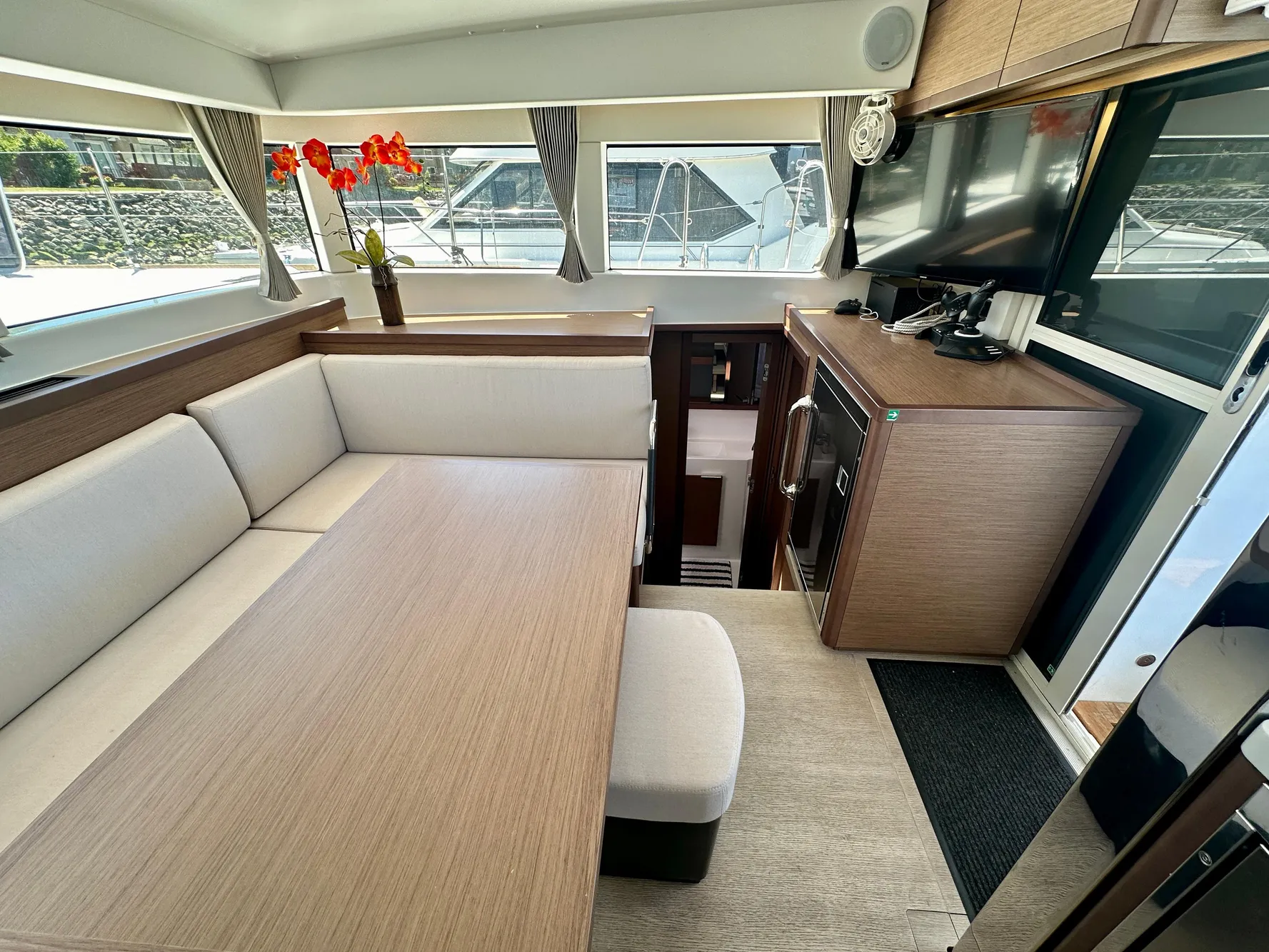 Lagoon 40 yacht interior, 2020 model, featuring modern seating and dining area with large windows.