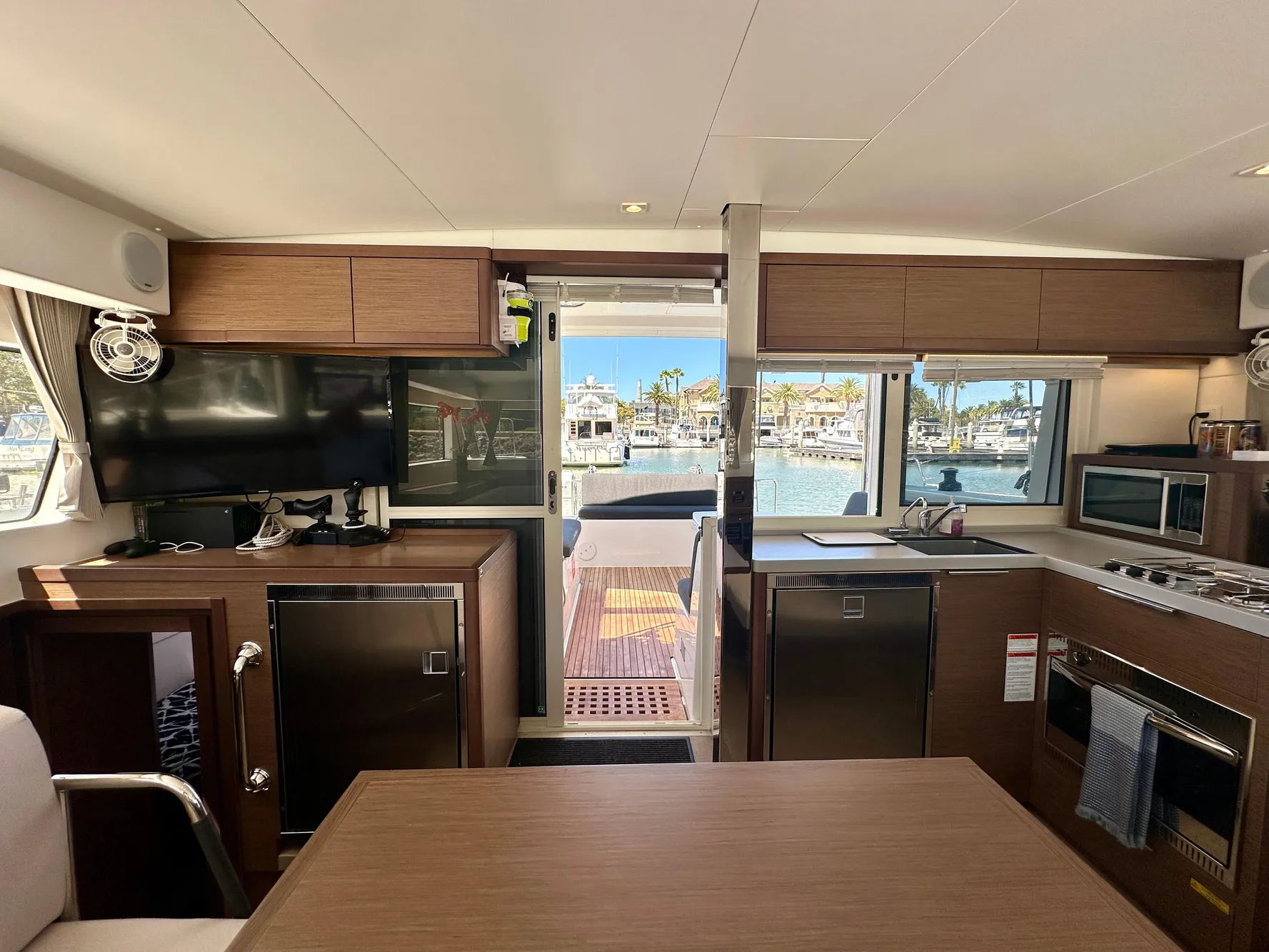 Interior of 2020 Lagoon 40 catamaran with modern kitchen and marina view.