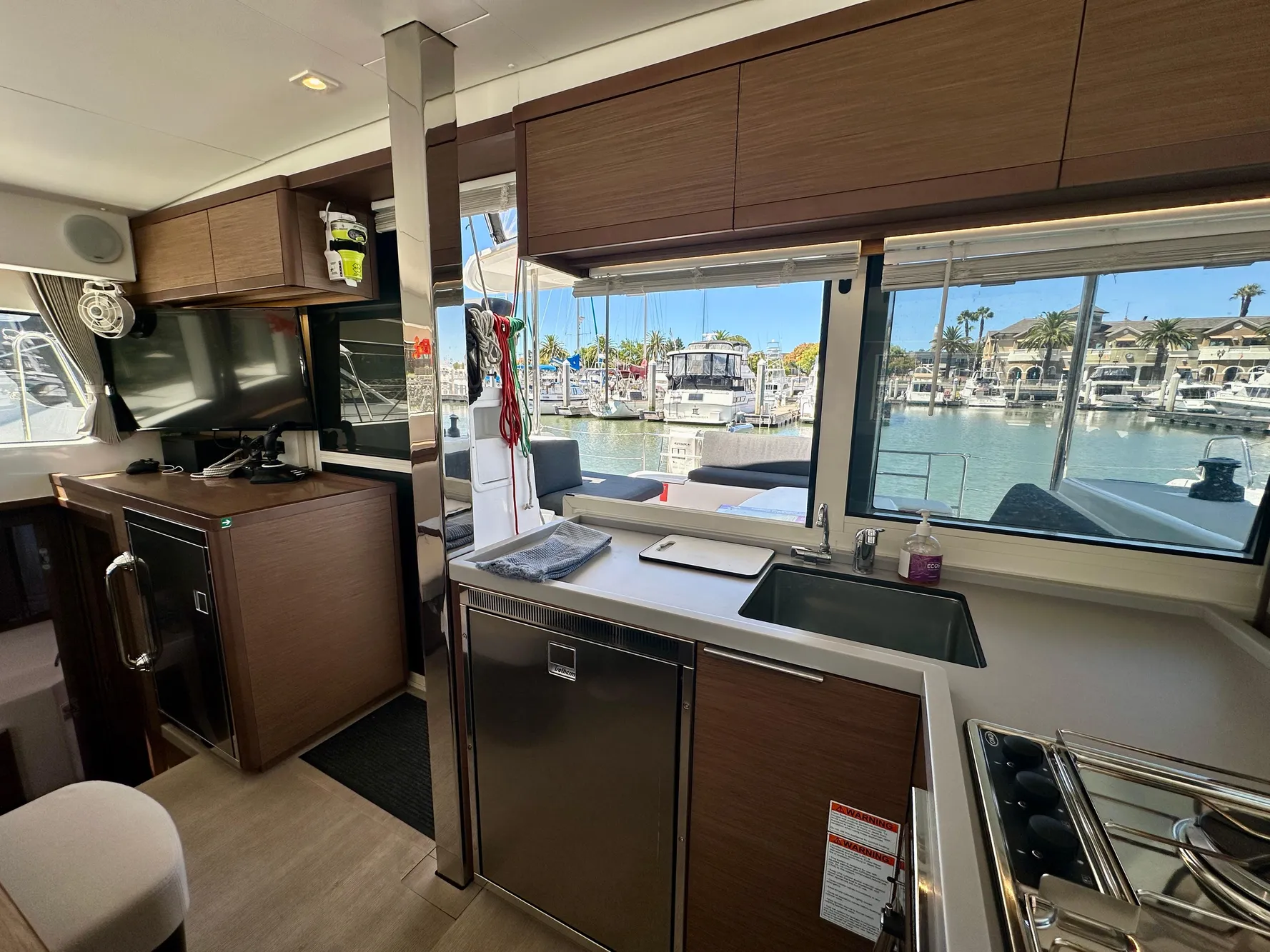 Interior of 2020 Lagoon 40 catamaran with modern kitchen and marina view.