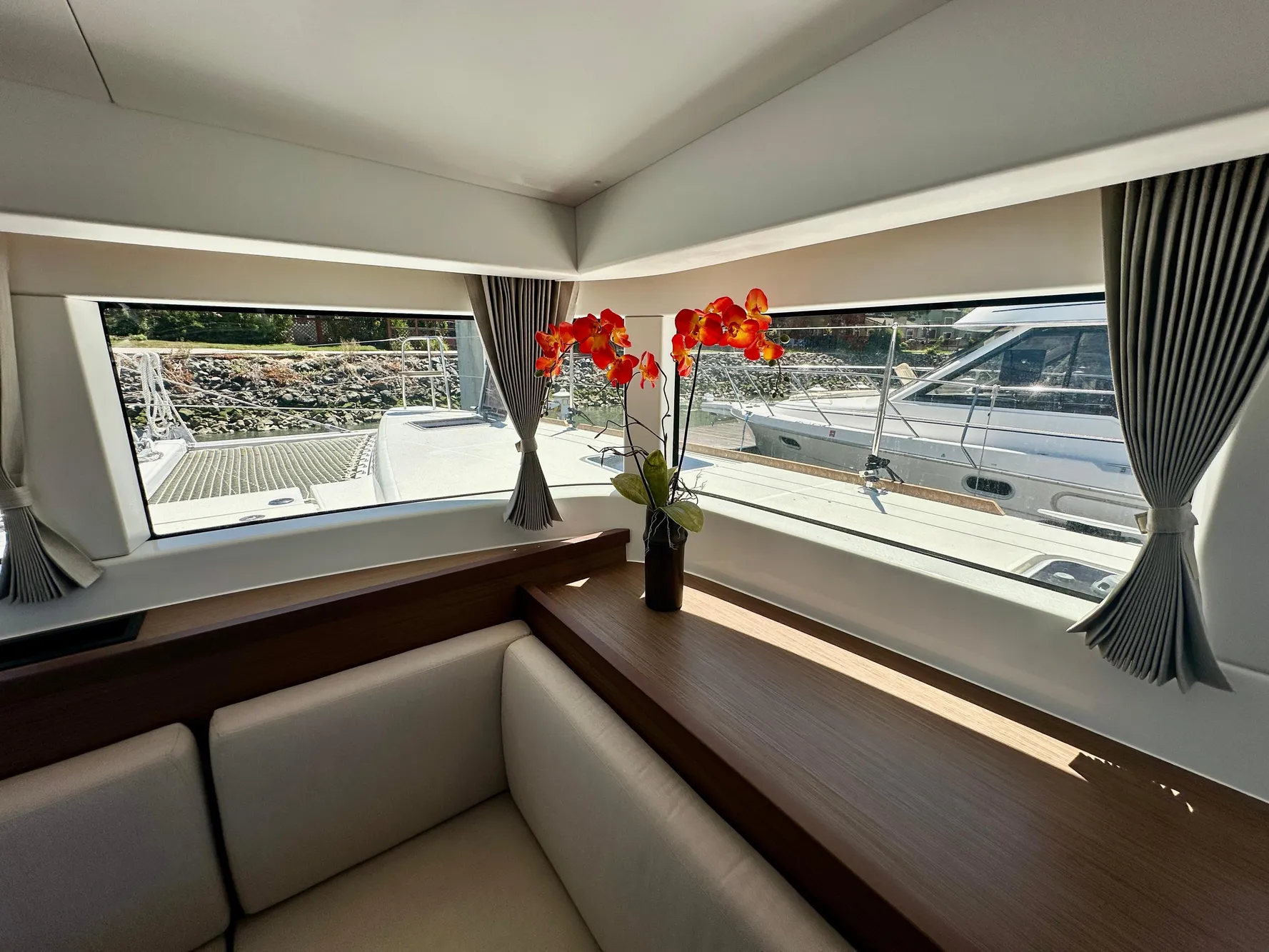 Interior of 2020 Lagoon 40 yacht with elegant seating and floral decor.