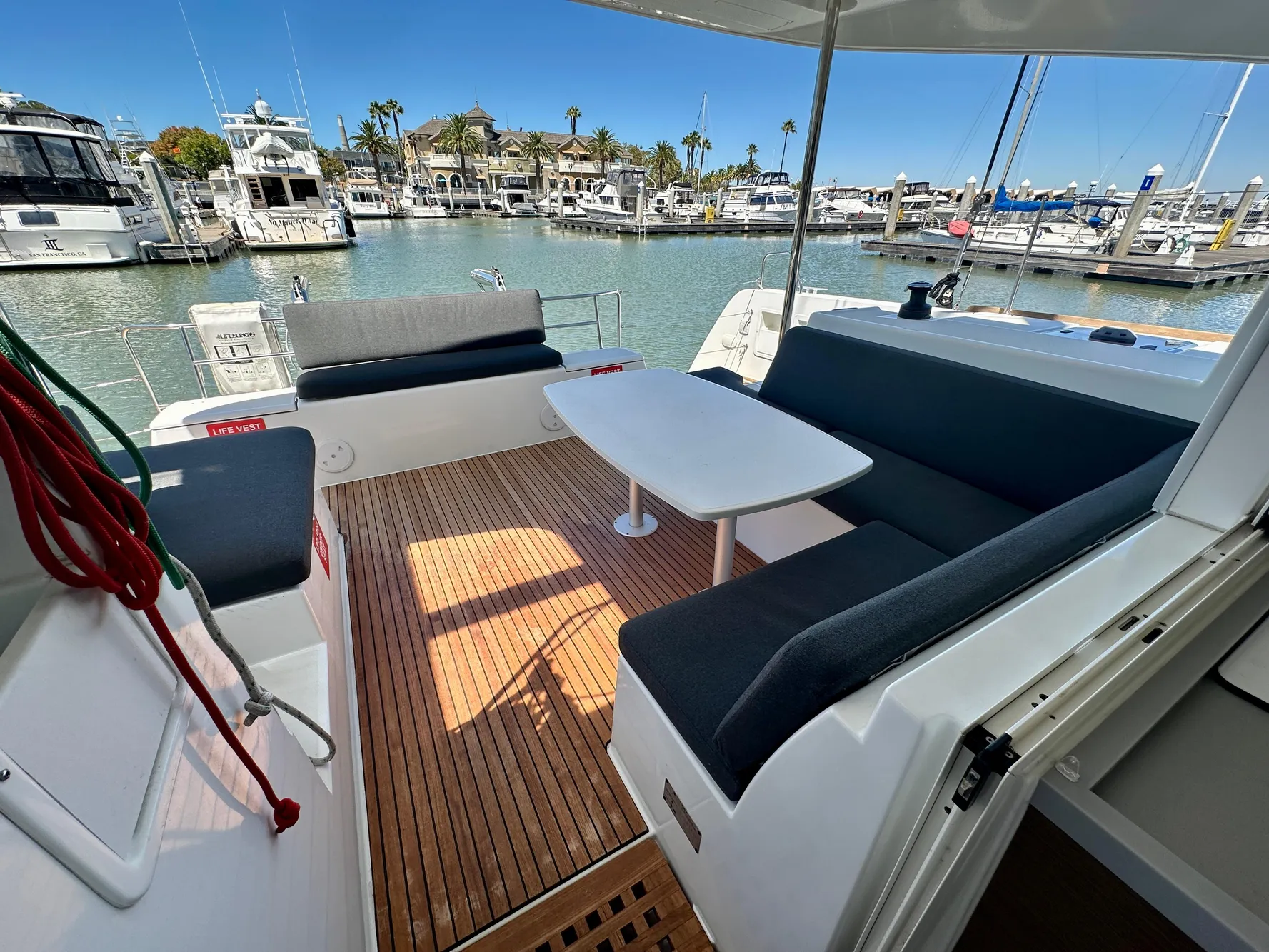 Lagoon 40 catamaran 2020 model, featuring a spacious outdoor seating area in a marina.