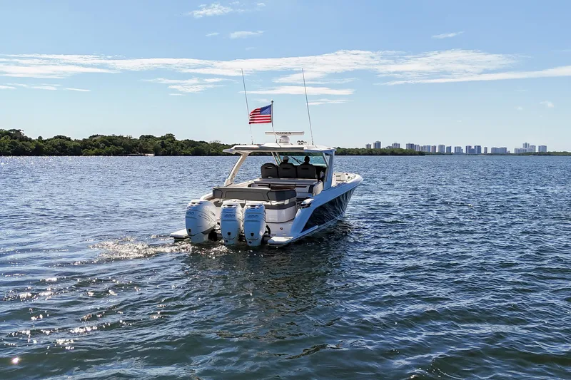 La Dolce Vita Yacht Photos Pics 2020 Tiara Yachts 38 LS cruising on a sunny day with city skyline in background.
