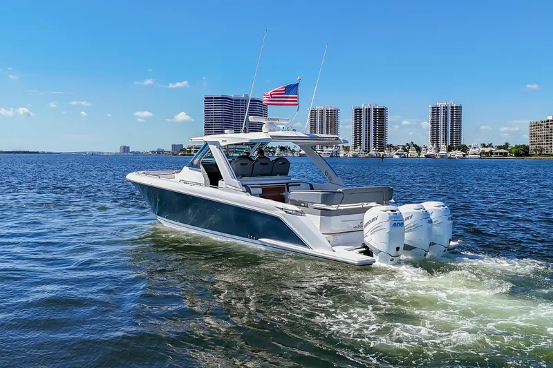 La Dolce Vita Yacht Photos Pics 2020 Tiara Yachts 38 LS cruising on a sunny day with city skyline backdrop.