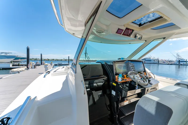 La Dolce Vita Yacht Photos Pics 2020 Tiara Yachts 38 LS cockpit view at marina, showcasing helm and seating.