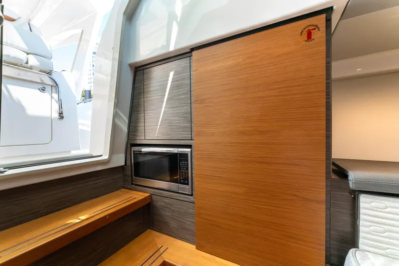 La Dolce Vita Yacht Photos Pics Interior of 2020 Tiara Yachts 38 LS featuring a modern kitchenette with microwave.