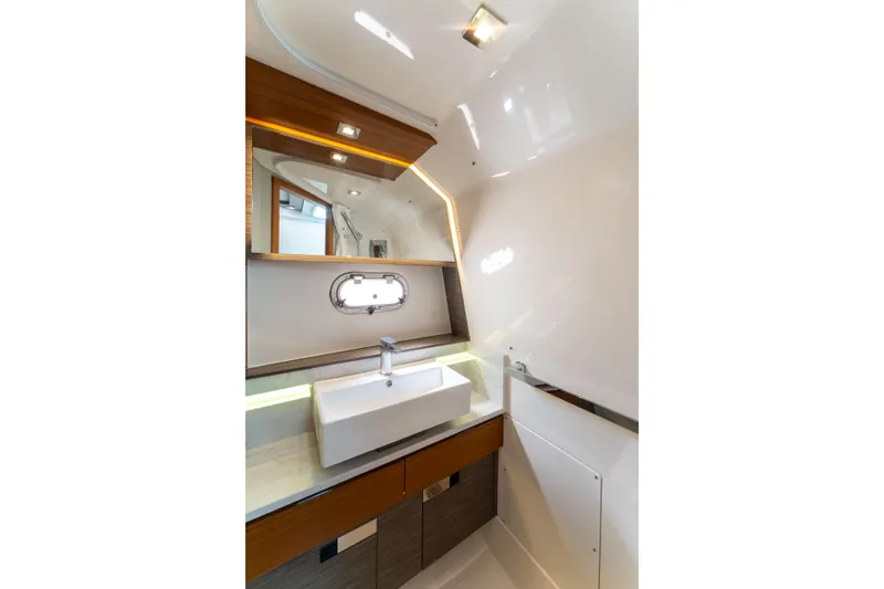 La Dolce Vita Yacht Photos Pics Luxurious bathroom interior of 2020 Tiara Yachts 38 LS with modern sink and mirror.