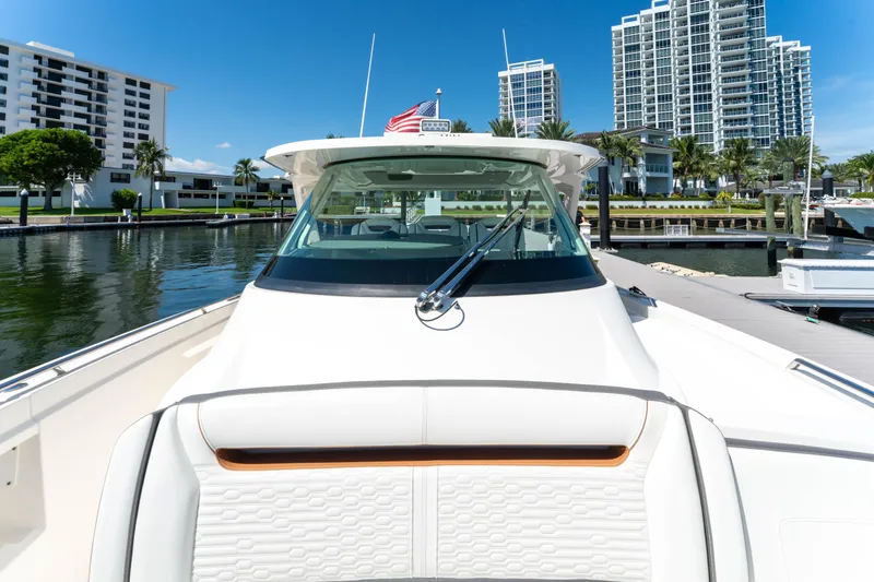 La Dolce Vita Yacht Photos Pics 2020 Tiara Yachts 38 LS docked near modern waterfront buildings.