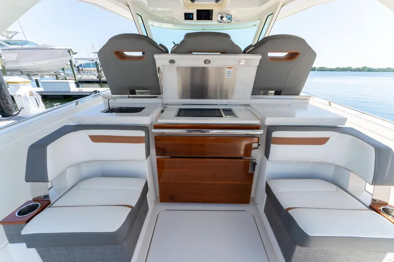 La Dolce Vita Yacht Photos Pics 2020 Tiara Yachts 38 LS interior with seating and kitchenette, docked at marina.