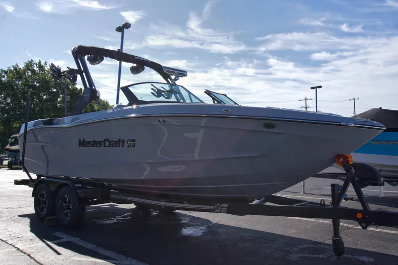  Yacht Photos Pics 2025 MasterCraft XT23 boat on trailer under clear sky.