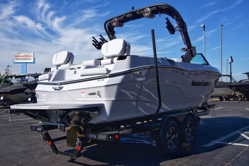  Yacht Photos Pics 2025 MasterCraft XT23 boat on trailer in dealership lot.
