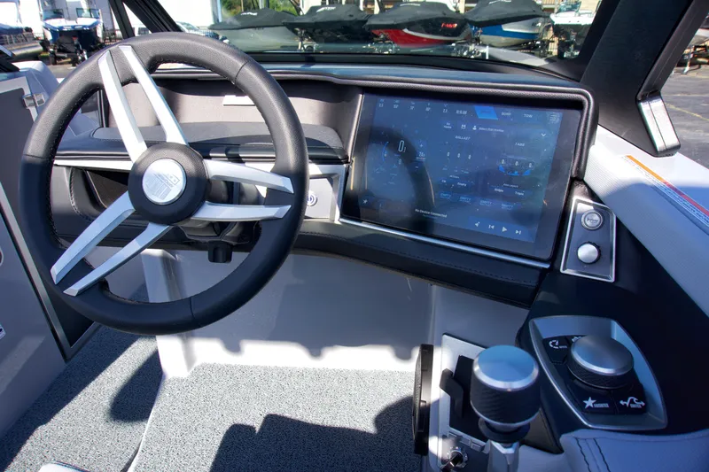  Yacht Photos Pics 2025 MasterCraft XT23 boat dashboard with touchscreen and steering wheel.