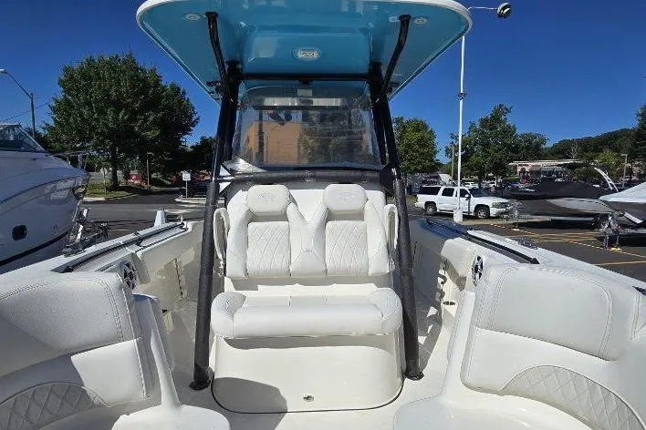  Yacht Photos Pics 2026 Key West 263 FS boat interior with white seating and blue canopy.
