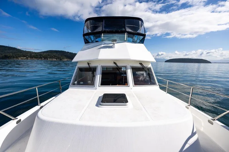  Yacht Photos Pics Symbol 42 Classic Trawler 2000 on calm waters under a blue sky.