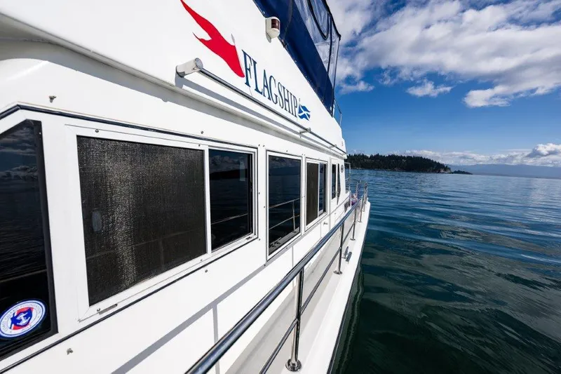 Yacht Photos Pics Symbol 42 Classic Trawler 2000 on calm water under blue sky.