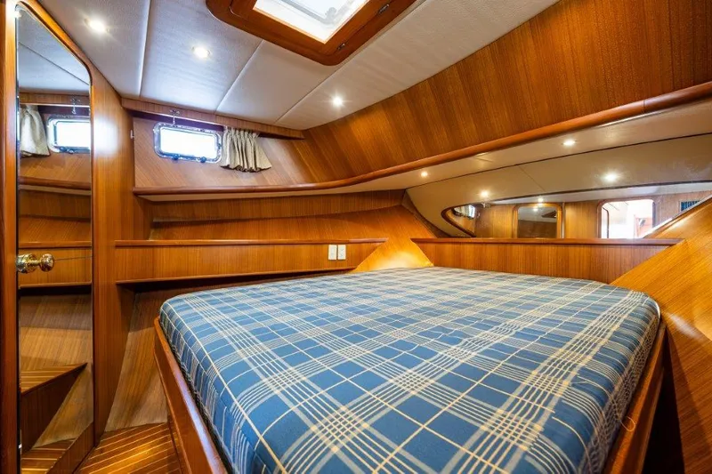  Yacht Photos Pics Cozy cabin interior of 2000 Symbol 42 Classic Trawler with plaid bedding.