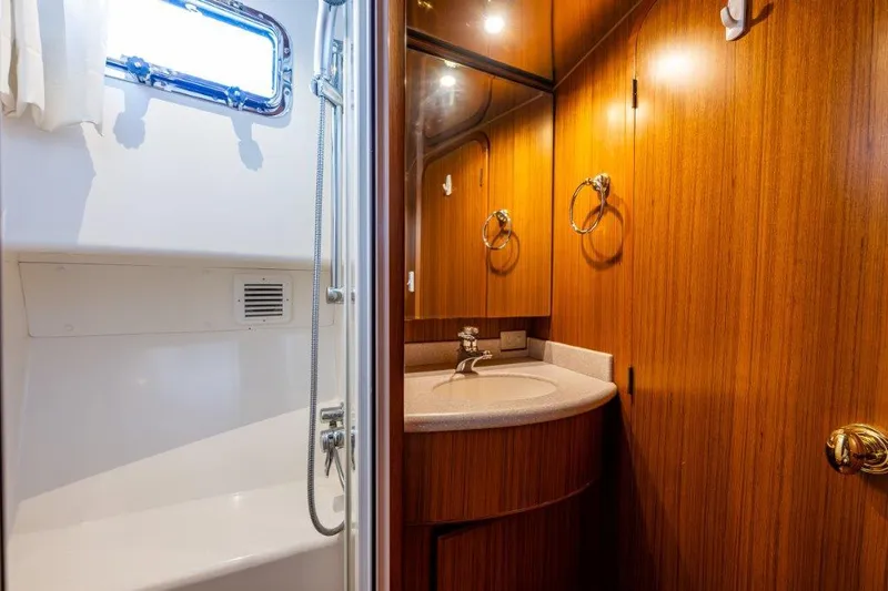  Yacht Photos Pics Bathroom interior of 2000 Symbol 42 Classic Trawler with wood cabinetry and shower.